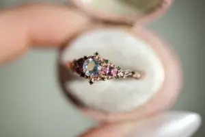 briar rose three stone with 5mm round moonstone and pink sapphire/green diamond accents