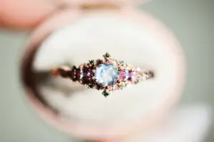 briar rose three stone with 5mm round moonstone and pink sapphire/green diamond accents