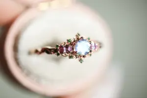 briar rose three stone with 5mm round moonstone and pink sapphire/green diamond accents
