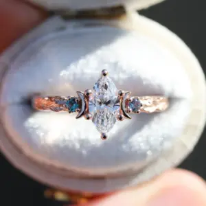 crescent moon three stone with 8x4mm marquise lab diamond