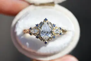 briar moon three stone with 8x5mm pear lab diamond and blue sapphire accents