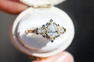 briar moon three stone with 8x5mm pear lab diamond and blue sapphire accents
