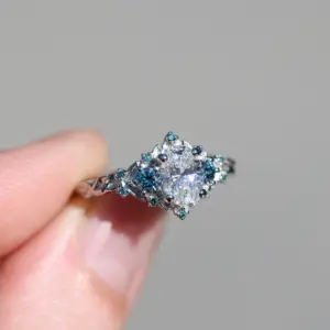 briar rose three stone with .7ct oval lab diamond and aqua diamond