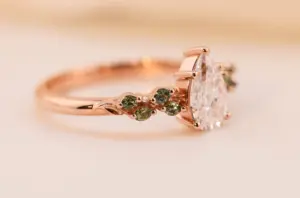 ivy setting with pear .75ct lab diamond and green sapphire
