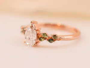 ivy setting with pear .75ct lab diamond and green sapphire
