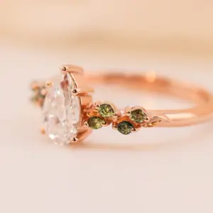 ivy setting with pear .75ct lab diamond and green sapphire