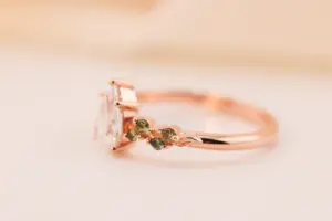 ivy setting with pear .75ct lab diamond and green sapphire