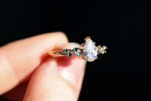 ivy setting with pear .75ct lab diamond and green sapphire