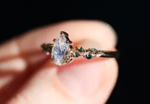 ivy setting with pear .75ct lab diamond and green sapphire