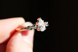 ivy setting with pear .75ct lab diamond and green sapphire