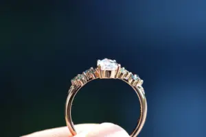 ivy setting with pear .75ct lab diamond and green sapphire