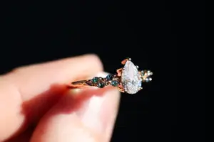ivy setting with pear .75ct lab diamond and green sapphire