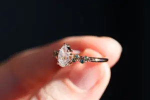 ivy setting with pear .75ct lab diamond and green sapphire