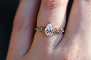 ivy setting with pear .75ct lab diamond and green sapphire