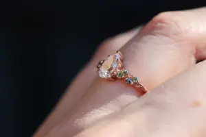 ivy setting with pear .75ct lab diamond and green sapphire