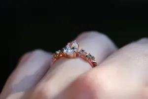ivy setting with pear .75ct lab diamond and green sapphire